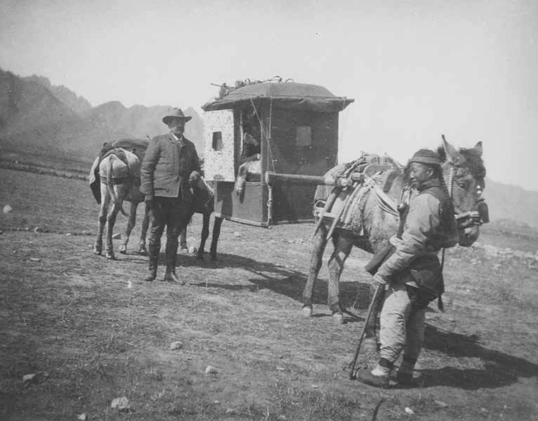 James Ragsdale and unidentified Chinese man standing next to palanquin probably carrying Effie Ragsdale (Chandless) on the way to Ming Tombs Peking China 1903 - Robert Henry Chandless |  - Robert Henry Chandless