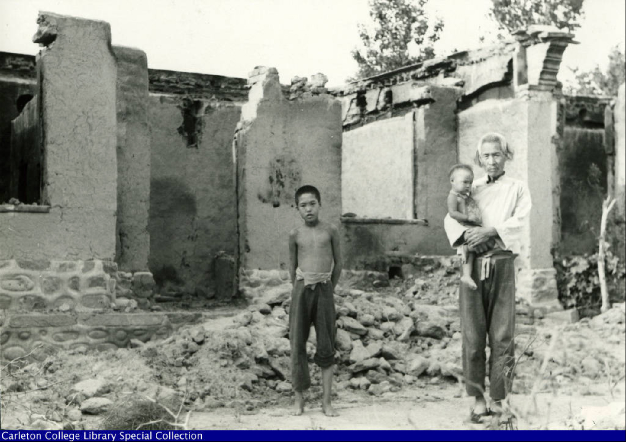 Haldore Hanson s China Collection (1937 1938) One family stands in front their property after the town was burned down by Japapese army attack 1938 - Haldore Hanson |  - Haldore Hanson